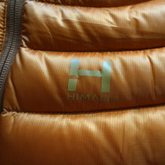 a close up photo of the screenprinted HIMALI logo on the accelerator down jacket. Did you know that there is the number 14 hidden within the H of the HIMALI logo? it represente the 14 x 8000m peaks