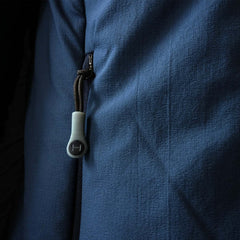 a closeup photo of the mens ascent stretch hoodie featuring the ykk zipper and custom himali zipper pulls