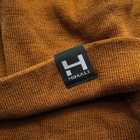 a close up product photo of the HIMALI Backcountry Beanie that shows the soft slightly ribbed fabric and custom woven label