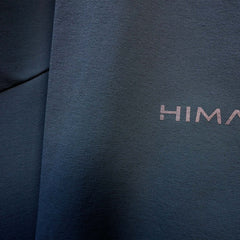 A fit photo of the HIMALI Mens Guide Flex Pant hilighting the 4way stretch fabric & reflective HIMALI logo