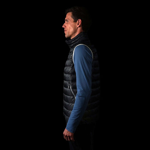 fit photo (side view) of the Men's focus down Vest in colorway Deep Space with 700 fill power hyperdry RDS certified down with a mindful blue pursuit longsleeve underneath