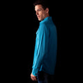 A side-profile fit photo of the HIMALI mens jetsetter ultra-vent button down shirt in the colorway ELECTRIC TEAL on a male model