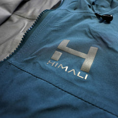 A closeup photo of the screenprinted HIMALI logo and fully seam taped waterproof YKK zippers on Eco-DWR coated 20K/20K breathable waterproof membrane