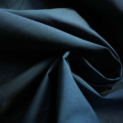 A closeup photo of the blue exterior fabric of the Monsoon Hardshell Eco-DWR coated 20K/20K waterproof breathable membrane