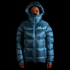A fit photo of a person wearing the altitude down jacket as seen from the front wearing the helmet compatable hood & hilighting the oversized fit designed for layering