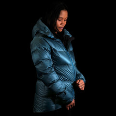 A fit photo of a person wearing the altitude down jacket as seen from the side. the wearing is using the ykk zippers