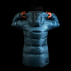 A fit photo of a person wearing the altitude down jacket as seen from the back hilighting the oversized fit designed for layering