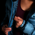 A fit photo of a person wearing the altitude down jacket as seen from the front & the person is using the oversized internal mesh pocket that can fit a pair of winter gloves. There is also an internal chest pocket using a YKK ziper that can easily fit you