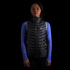 fit photo of the Women's Focus Down Vest in colorway Deep Space with 700 fill power hyperdry RDS certified down with a lupine pursuit longsleeve underneath