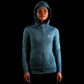 The front view of a model wearing the Women Momentum YKK Zipper Hoodie with the Hood up