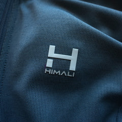 a closeup view of the HIMALI Logo and the quick drying and moisture wicking Polartec fabric of the Women's Momentum Hoodie