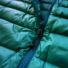 a close up detail photo of the peak 7 down jacket's YKK zippers with custom HIMALI zipper pullers