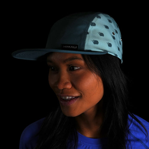 Woman wearing the Boulder 5 Panel Hat, Yak Print in color Evening Mist made with premium materials