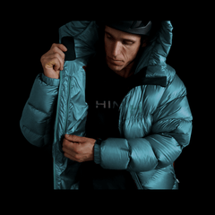  A fit photo of a person wearing the altitude down jacket as seen from the front & the person is using the oversized internal mesh pocket that can fit a pair of winter gloves. There is also an internal chest pocket using a YKK ziper that can easily fit yo