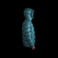 A fit photo of a person wearing the altitude down jacket as seen from the side