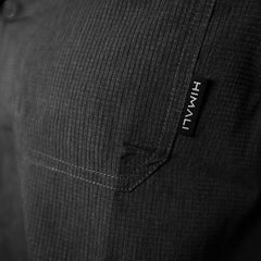 A close up photo of the front chest pocket on the HIMALI men's Jetsetter ultra-vent button down shirt in the colorway charcoal