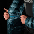 a fit photo of the mens accelerator down jacket that shows a man using the inside YKK zipper pocket of the jacket. The pocket is big enough to fit most phones. 